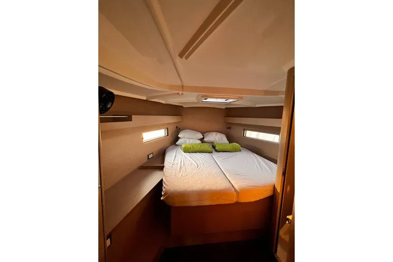  Yacht Photos Pics Cozy cabin interior of 2022 Beneteau Oceanis 40.1 yacht with double bed and natural lighting.
