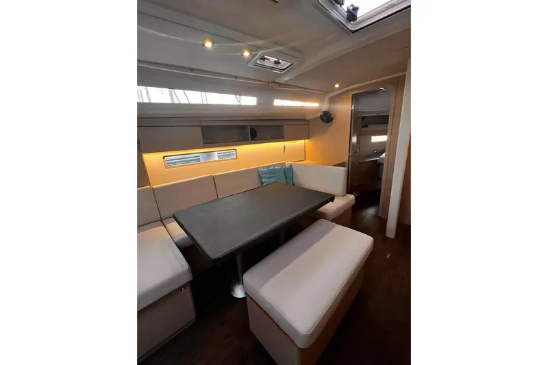  Yacht Photos Pics Interior of 2022 Beneteau Oceanis 40.1 yacht, featuring modern dining area with cushioned seating.