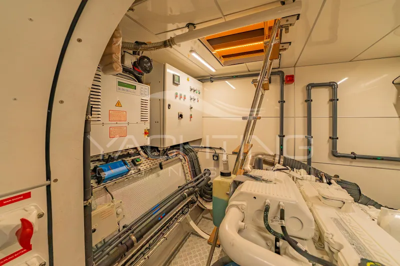 4ever Yacht Photos Pics Engine room of 2022 JFA Yachts LONG ISLAND 78 POWER, featuring control panels and machinery.