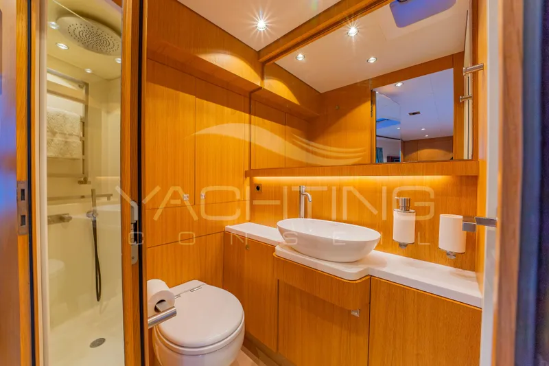 4ever Yacht Photos Pics Luxurious bathroom in 2022 JFA Yachts LONG ISLAND 78 POWER, featuring modern fixtures and wood accents.