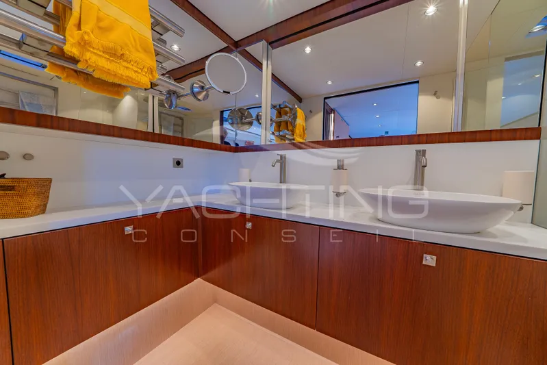 4ever Yacht Photos Pics Luxurious bathroom in 2022 JFA Yachts LONG ISLAND 78 POWER, featuring dual sinks and elegant wood cabinetry.