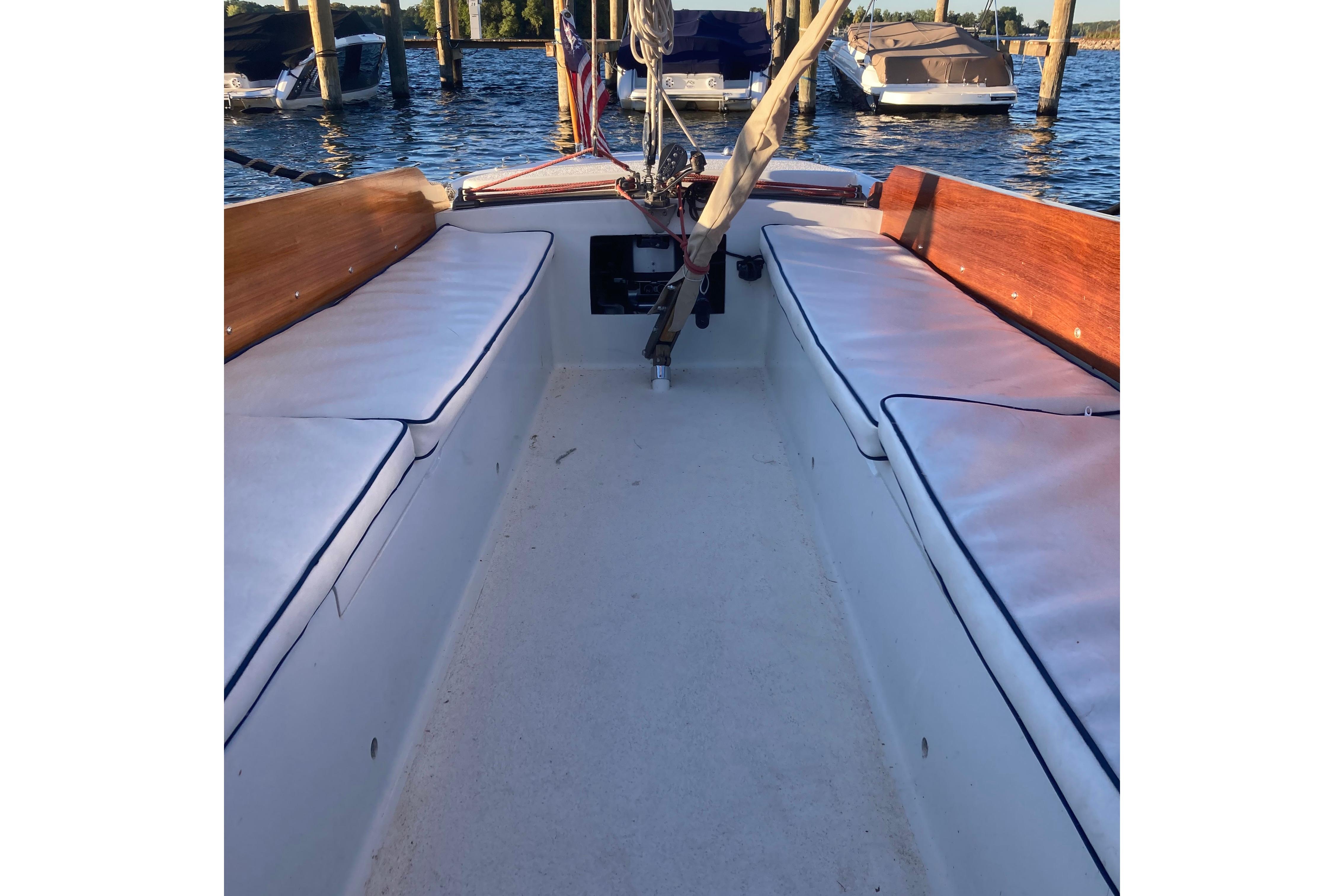 1964 Pearson Commander sailboat interior with cushioned seating and wooden accents.