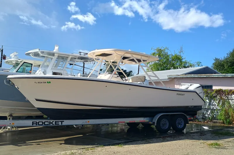 280-117 Brokerage Joe Yacht Photos Pics 2010 Pursuit S 280 Sport boat on trailer under blue sky.