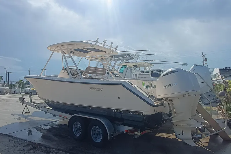 280-117 Brokerage Joe Yacht Photos Pics 2010 Pursuit S 280 Sport boat on trailer with Yamaha engines in a marina.