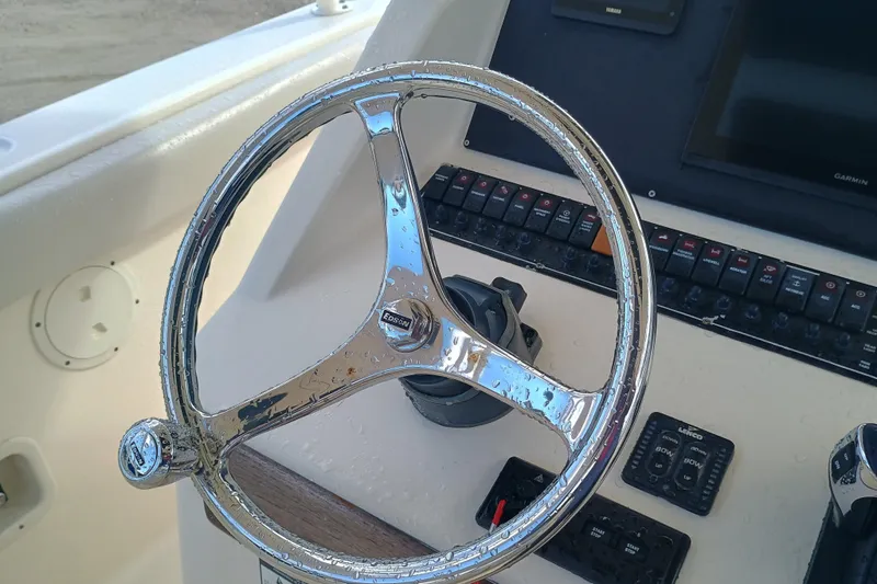 280-117 Brokerage Joe Yacht Photos Pics Steering wheel of 2010 Pursuit S 280 Sport boat with control panel.