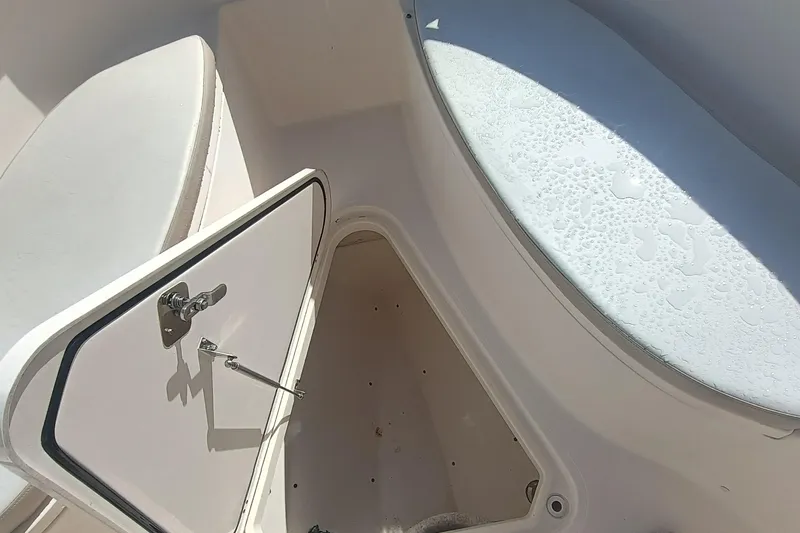 280-117 Brokerage Joe Yacht Photos Pics 2010 Pursuit S 280 Sport boat interior storage compartment with open hatch.