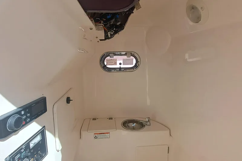 280-117 Brokerage Joe Yacht Photos Pics Interior cabin of 2010 Pursuit S 280 Sport boat with sink and control panel.