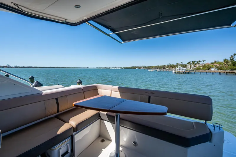  Yacht Photos Pics Sea Ray Sundancer 400 yacht interior with seating and table, overlooking serene waters.