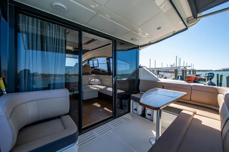  Yacht Photos Pics Luxurious 2017 Sea Ray Sundancer 400 yacht interior with seating and table, docked at marina.