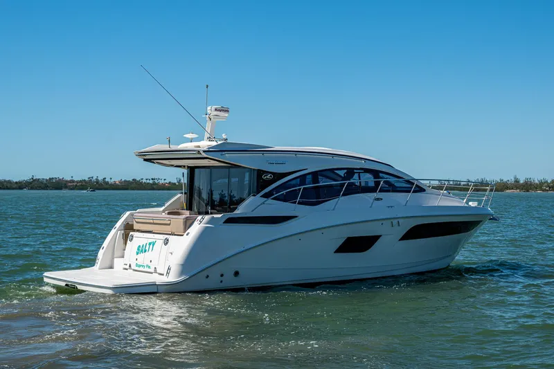  Yacht Photos Pics 2017 Sea Ray Sundancer 400 yacht cruising on open water under clear blue skies.