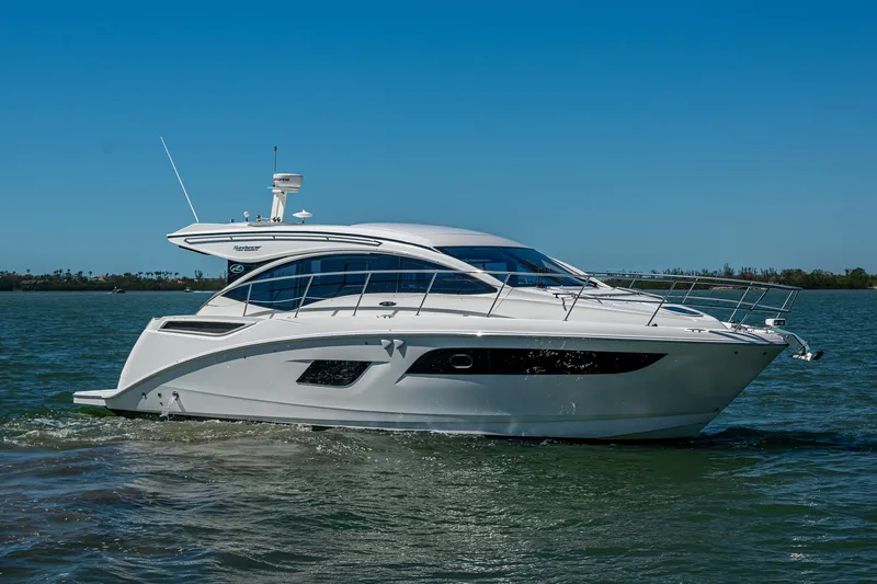  Yacht Photos Pics 2017 Sea Ray Sundancer 400 yacht cruising on calm waters under clear blue skies.