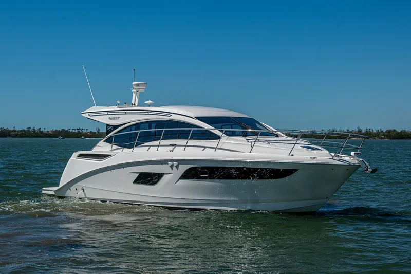  Yacht Photos Pics 2017 Sea Ray Sundancer 400 yacht cruising on open water under clear blue skies.