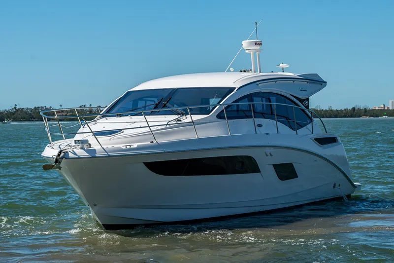  Yacht Photos Pics 2017 Sea Ray Sundancer 400 yacht cruising on open water under clear blue skies.