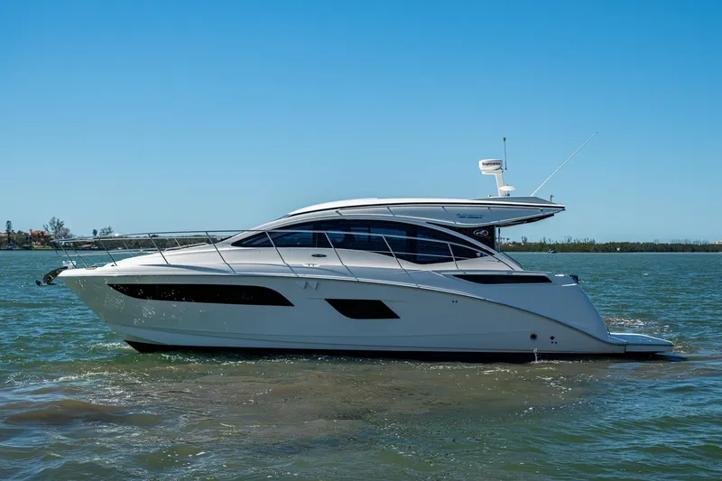  Yacht Photos Pics 2017 Sea Ray Sundancer 400 yacht cruising on calm waters under a clear blue sky.