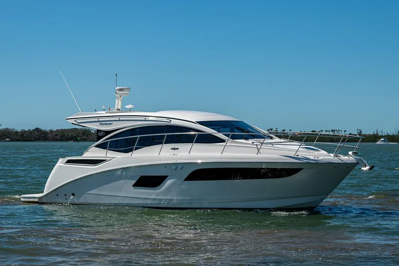  Yacht Photos Pics 2017 Sea Ray Sundancer 400 yacht cruising on calm waters under clear blue sky.