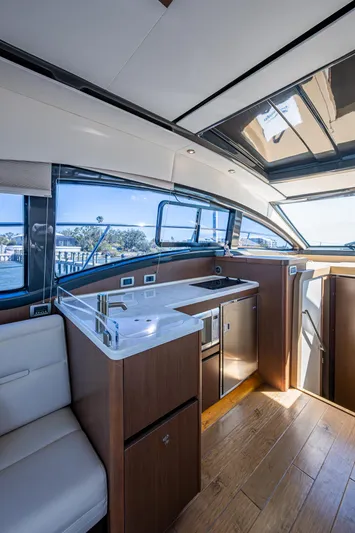  Yacht Photos Pics Interior of 2017 Sea Ray Sundancer 400 yacht, featuring modern kitchen and seating area.