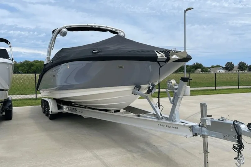  Yacht Photos Pics 2024 Sea Ray SDX 290 Outboard boat on trailer, covered, parked outdoors.