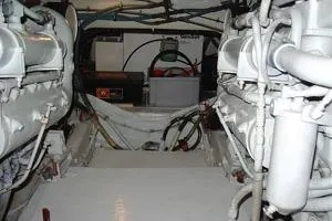  Yacht Photos Pics Engine room of a 1987 Bertram 37 Convertible boat, showcasing dual engines and wiring.