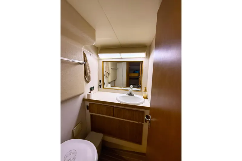  Yacht Photos Pics Bathroom interior of 1987 Bertram 37 Convertible yacht, featuring sink and mirror.