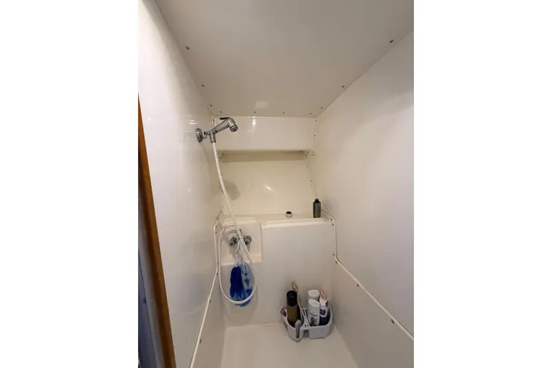  Yacht Photos Pics Shower area in 1987 Bertram 37 Convertible boat, featuring white walls and toiletries.
