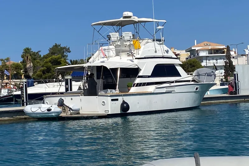  Yacht Photos Pics 1987 Bertram 37 Convertible yacht docked in a sunny marina setting.