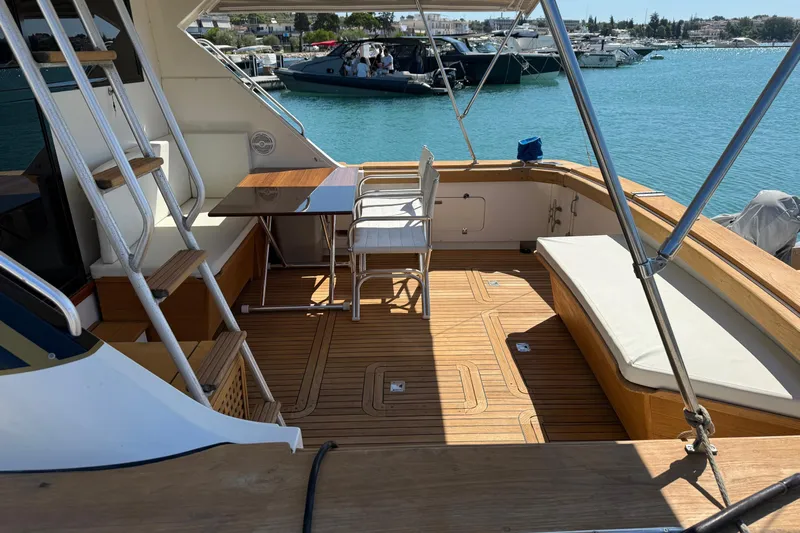  Yacht Photos Pics 1987 Bertram 37 Convertible yacht deck with seating, table, and marina view.