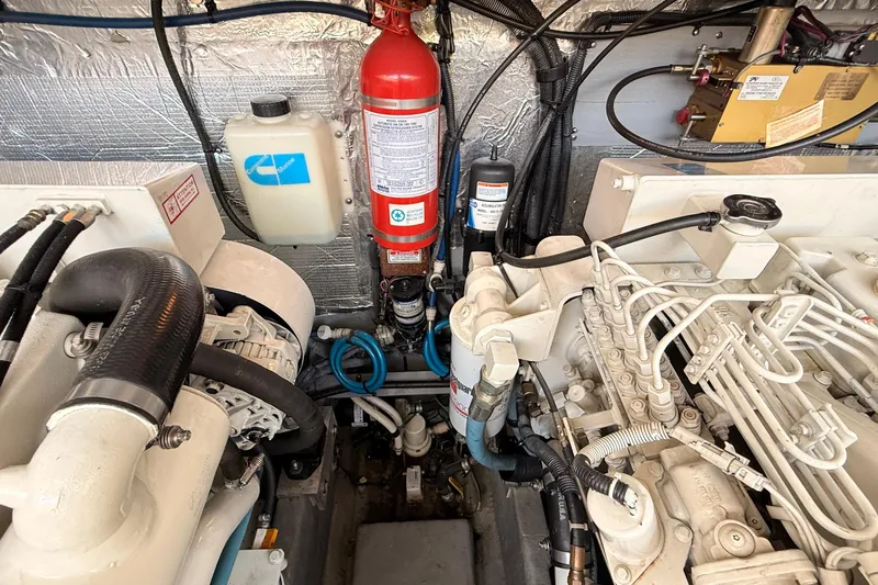 Banking Memories Yacht Photos Pics Engine room of 2001 Sea Ray 410 Express Cruiser with fire extinguisher and mechanical components.