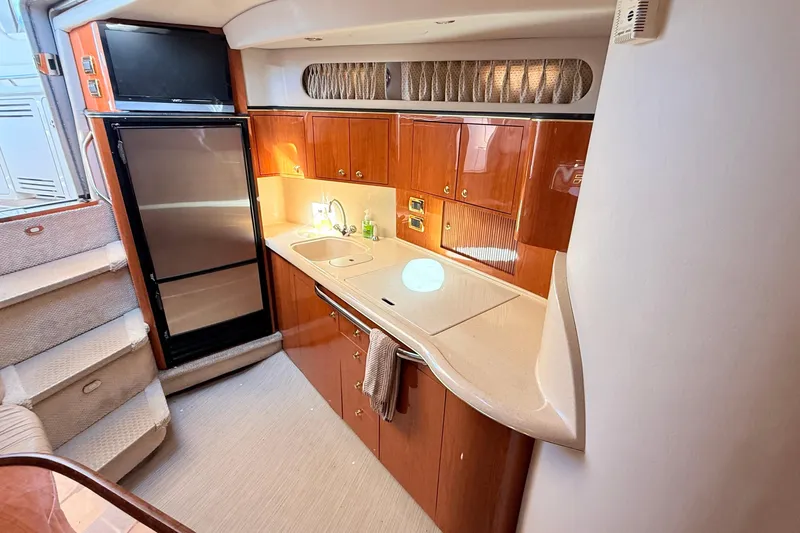 Banking Memories Yacht Photos Pics 2001 Sea Ray 410 Express Cruiser kitchen with wood cabinets and modern appliances.
