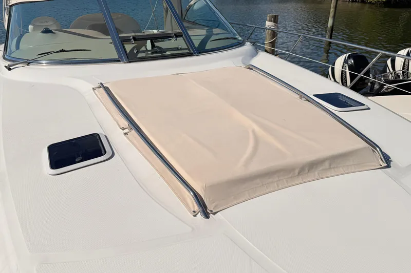 Banking Memories Yacht Photos Pics 2001 Sea Ray 410 Express Cruiser deck with sunpad and hatches, docked by the water.