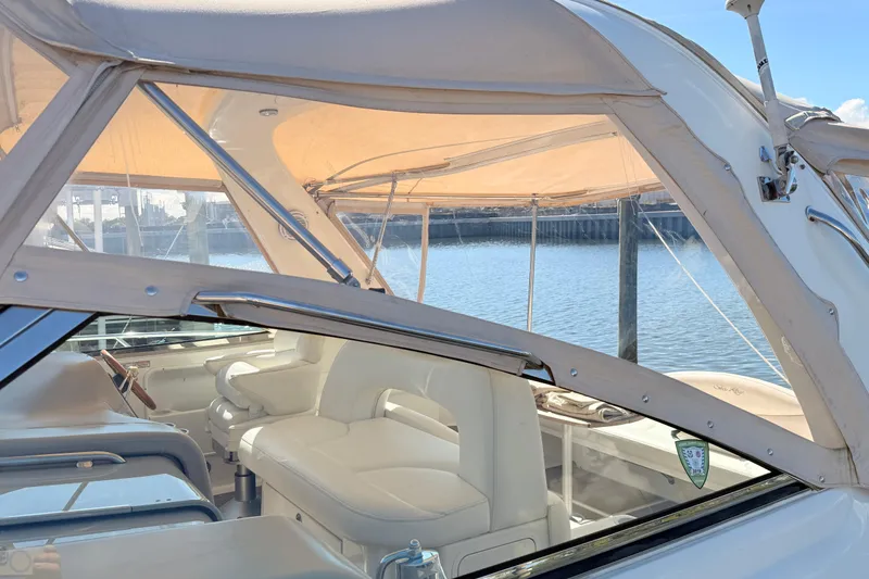 Banking Memories Yacht Photos Pics 2001 Sea Ray 410 Express Cruiser interior with beige seating and canopy, docked by the water.