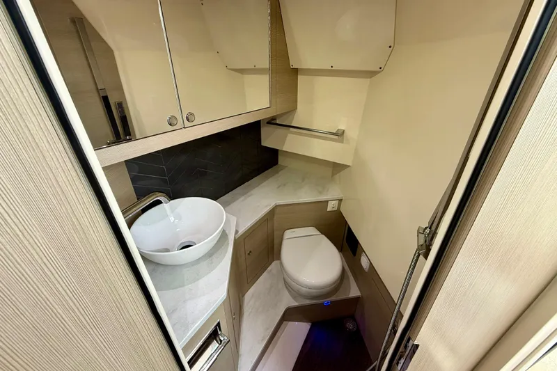  Yacht Photos Pics 2023 Scout 350 LXZ boat bathroom with modern sink and toilet.