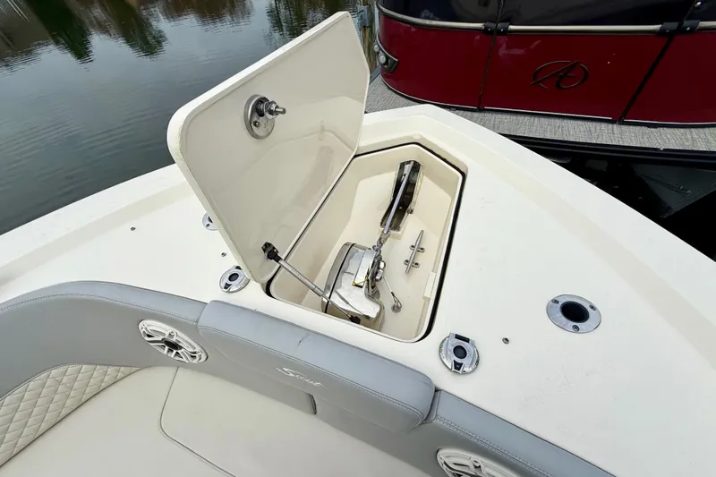  Yacht Photos Pics 2023 Scout 350 LXZ boat anchor compartment with open hatch, docked near water.