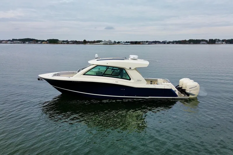  Yacht Photos Pics 2023 Scout 350 LXZ boat on calm water, side view.