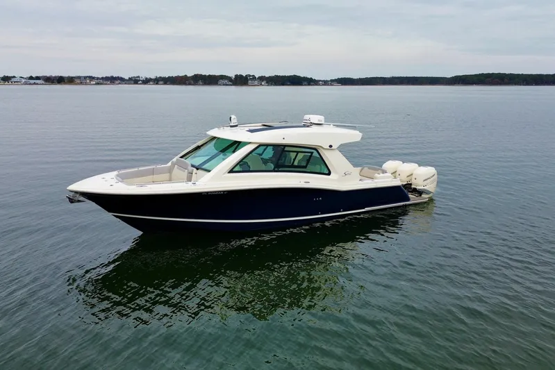  Yacht Photos Pics 2023 Scout 350 LXZ boat on calm water, showcasing sleek design and modern features.