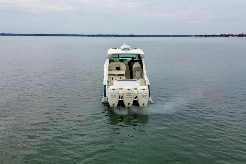  Yacht Photos Pics 2023 Scout 350 LXZ boat with triple engines on calm water.