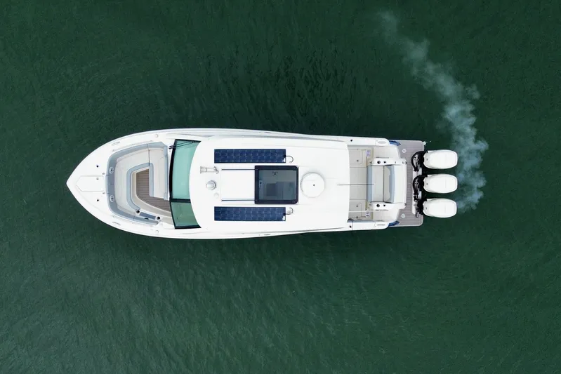  Yacht Photos Pics Aerial view of 2023 Scout 350 LXZ boat on water with triple engines.