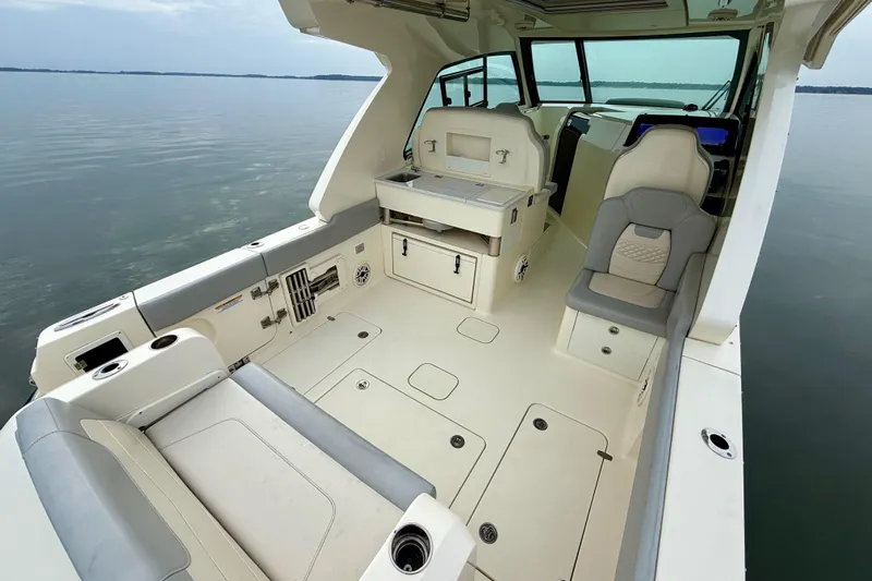  Yacht Photos Pics 2023 Scout 350 LXZ boat interior with seating and storage on calm water.