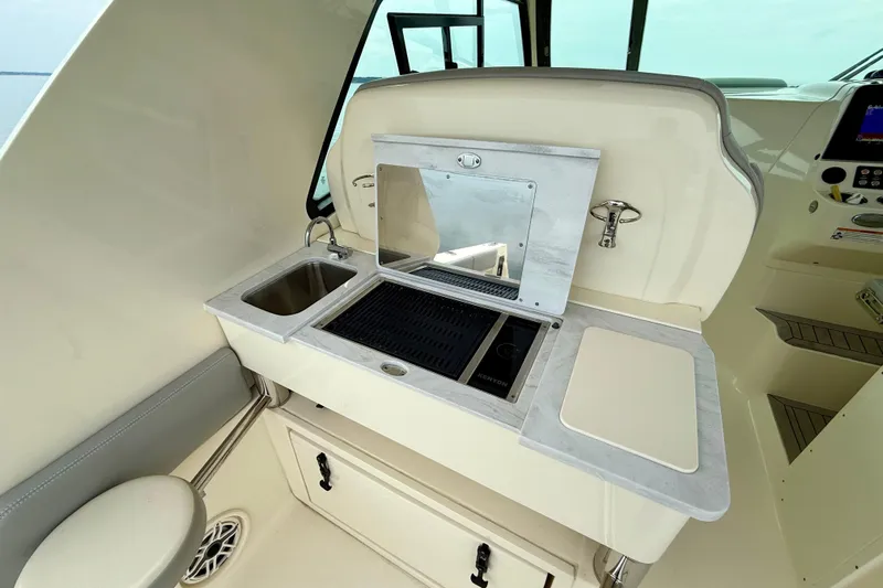  Yacht Photos Pics 2023 Scout 350 LXZ boat interior with kitchenette, sink, and grill.