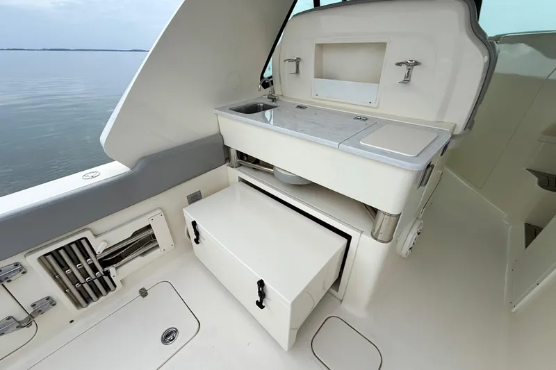  Yacht Photos Pics 2023 Scout 350 LXZ boat interior with sink and storage compartments.