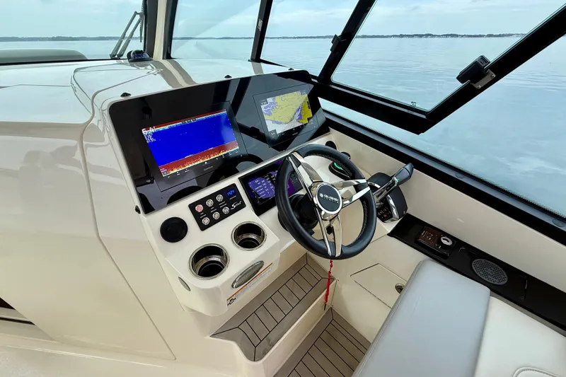  Yacht Photos Pics 2023 Scout 350 LXZ boat helm with advanced navigation displays and steering wheel.