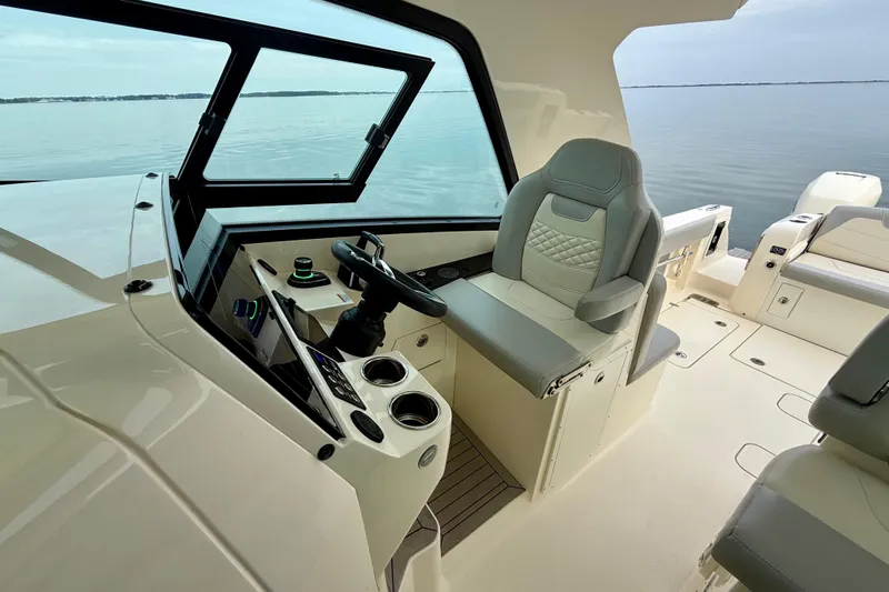  Yacht Photos Pics 2023 Scout 350 LXZ boat interior with helm, luxurious seating, and panoramic water view.