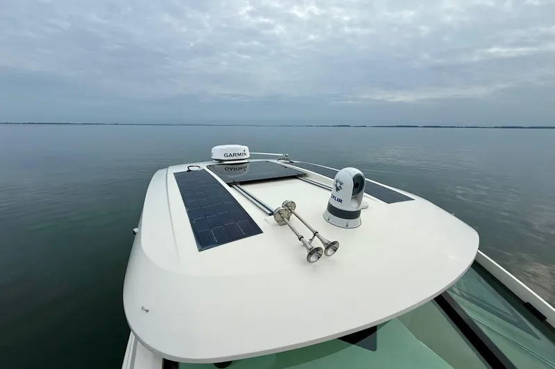  Yacht Photos Pics 2023 Scout 350 LXZ boat with solar panels and navigation equipment on calm water.