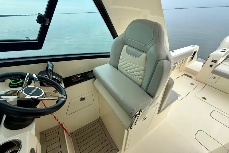  Yacht Photos Pics 2023 Scout 350 LXZ boat interior with steering wheel and luxurious seating.