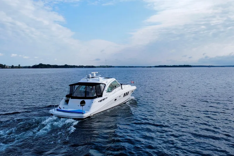  Yacht Photos Pics 2009 Sea Ray 48 Sundancer cruising on open water under a partly cloudy sky.