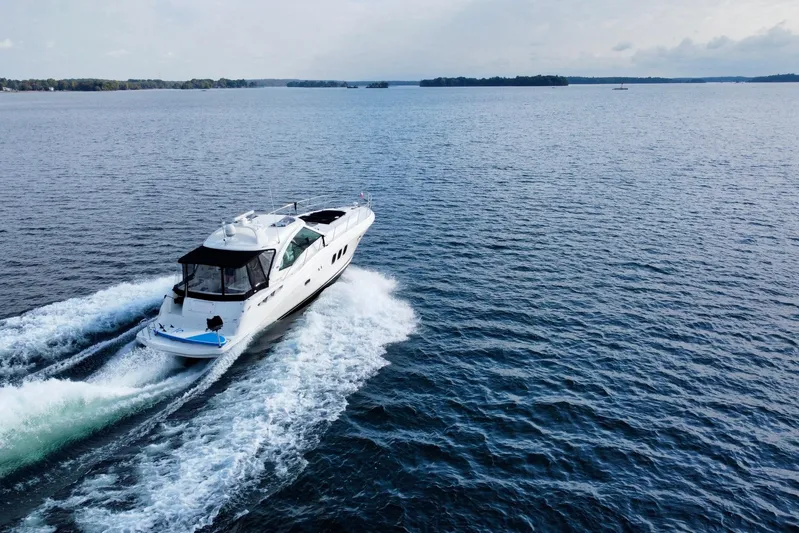  Yacht Photos Pics 2009 Sea Ray 48 Sundancer cruising on open water, creating a wake behind.