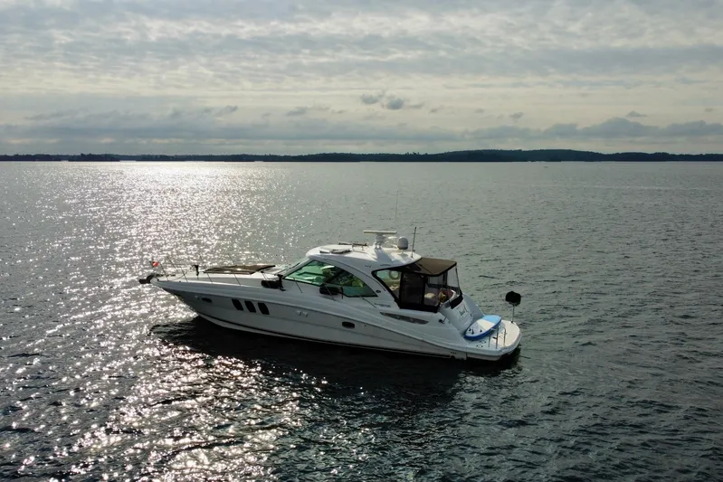  Yacht Photos Pics 2009 Sea Ray 48 Sundancer yacht cruising on a sunlit, tranquil sea.