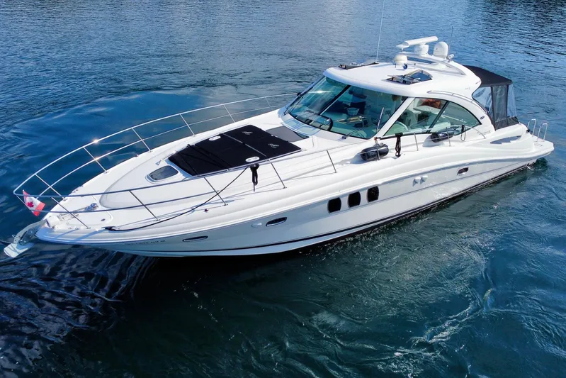  Yacht Photos Pics 2009 Sea Ray 48 Sundancer yacht cruising on calm blue waters.