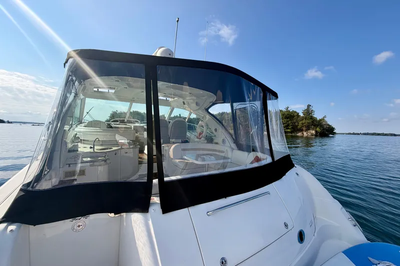  Yacht Photos Pics 2009 Sea Ray 48 Sundancer yacht on serene water with clear skies.