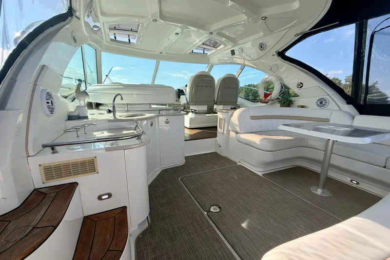  Yacht Photos Pics Luxurious interior of 2009 Sea Ray 48 Sundancer yacht with seating and kitchenette.