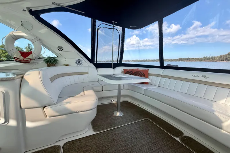  Yacht Photos Pics Luxurious interior of 2009 Sea Ray 48 Sundancer yacht with white seating and scenic water view.